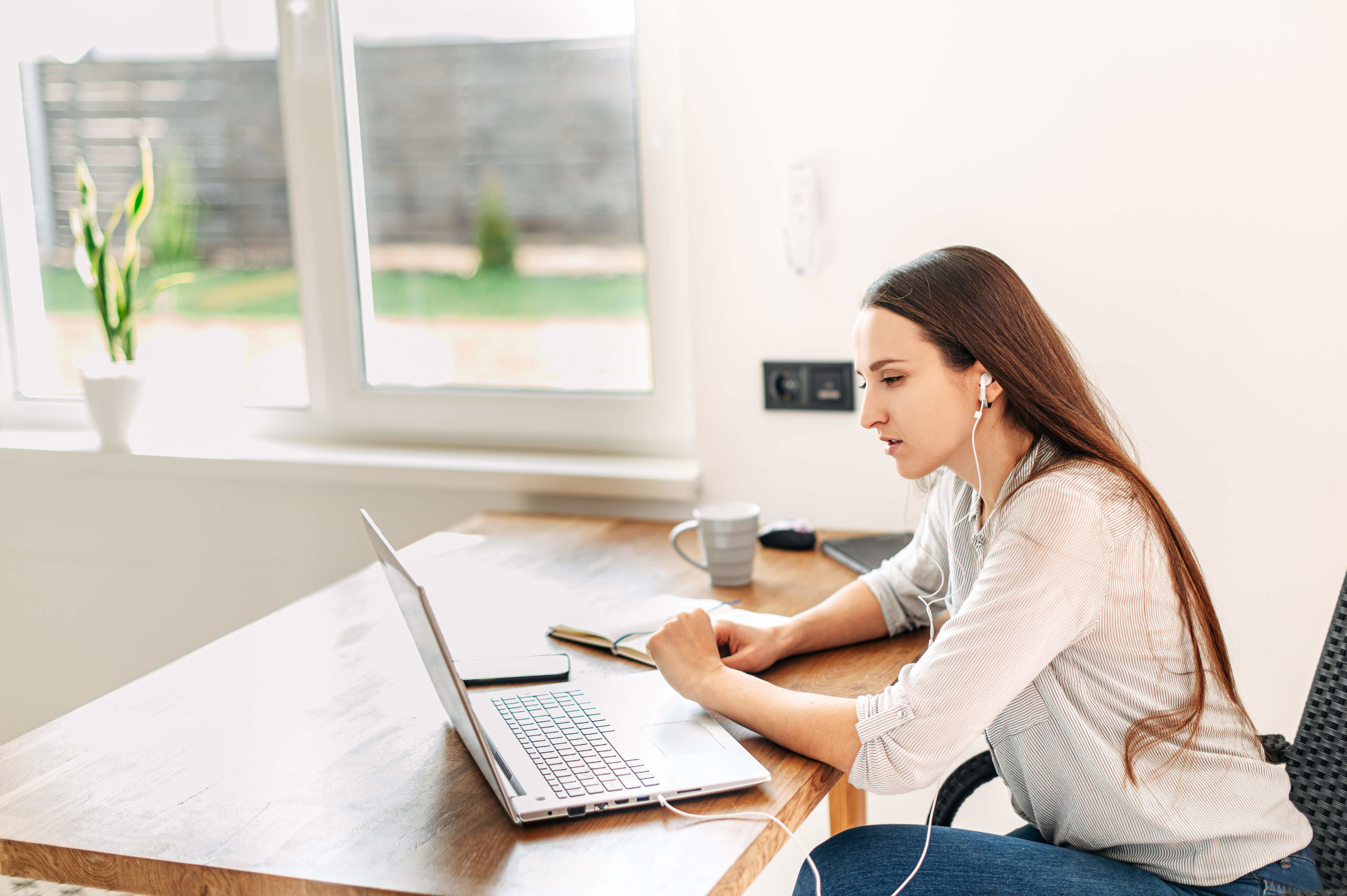 Woman uses laptop for video conference